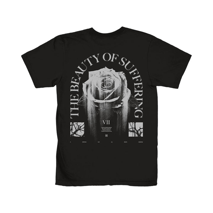Spiritbox black T-shirt with a large distressed white rose on the back, “THE BEAUTY OF SUFFERING” arched above, window-style graphics below, and VII in the center. Perfect for fans of The Beauty Of Suffering.