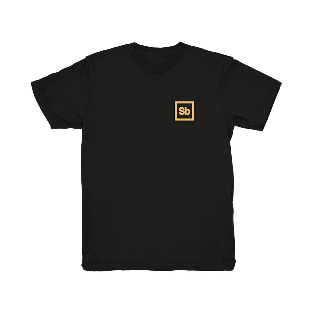 Black Spiritbox T-Shirt with a small yellow square on the left chest, featuring white "Sb" lettering at the center—an understated reference to the Perennial design.