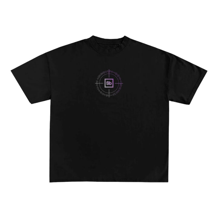 A Spiritbox Comfort Colors Heavyweight T-Shirt in plain black, garment-dyed for softness, features a small purple and white circular chest graphic with Sb inside a square.