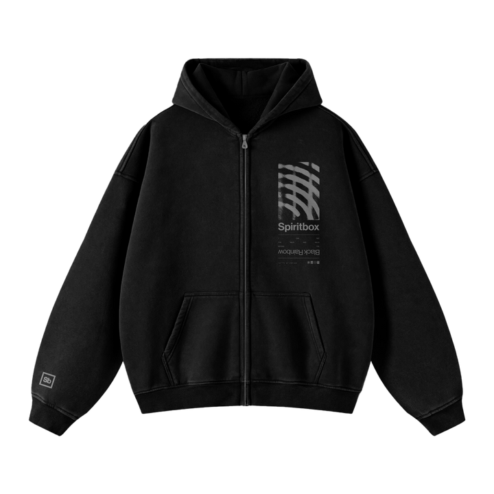 Spiritbox black zip-up sweatshirt with front pockets, gray abstract wave design, "Spiritbox" text, and small left chest print. Features a relaxed fit for comfort and a branded patch on the left sleeve.