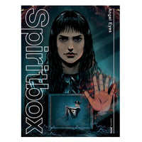 A dark-haired woman with a serious look faces forward, hand raised as if against glass. Below her, a smaller figure floats inside a glowing box. The image features the brand name “Spiritbox” and the text “Angel Eyes.”.