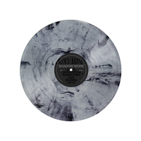 A limited edition marbled black and grey Holy Wars vinyl features the Shadow Work/Light Work LP. The label reads "Holy Wars - Shadow Work," with a white-on-black tracklist and a swirling, smoky pattern at the center.
