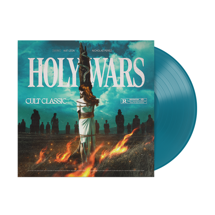 A limited edition aqua vinyl from Holy Wars, featuring a cover of a woman tied to a stake amid flames, shadowy figures behind her, and text reading "Holy Wars," "Cult Classic," plus an R rating.