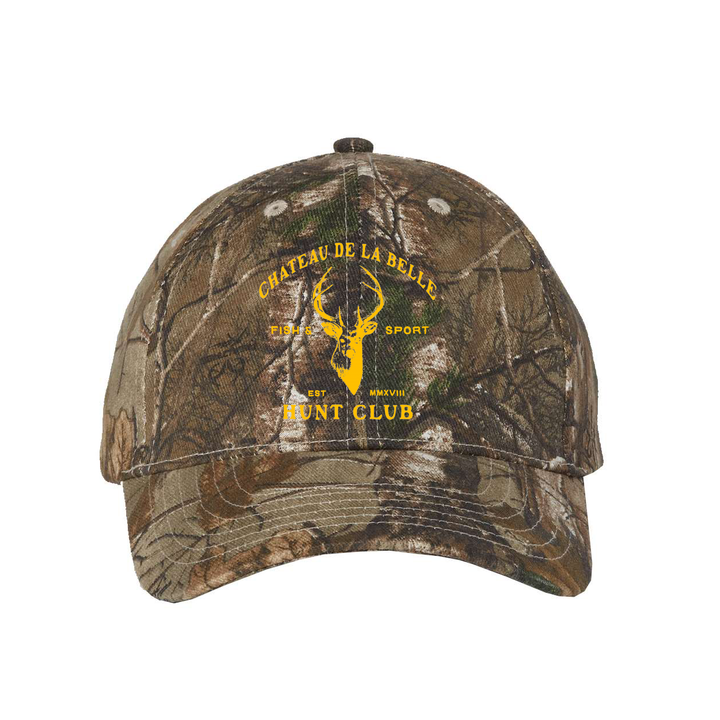 Kati Realtree Xtra camo dad hat with a yellow logo featuring a deer silhouette and the text Chateau de la Belle Hunt Club, Est MMXVIII.