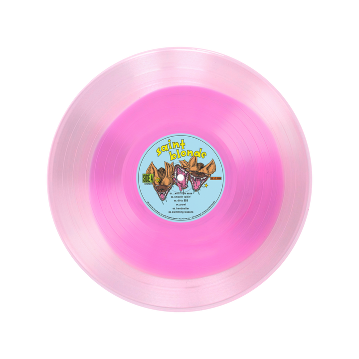 A translucent two-tone pink vinyl LP by Saint Blonde with a blue center label featuring illustrated animal faces, the brand name, and song titles along with side info.