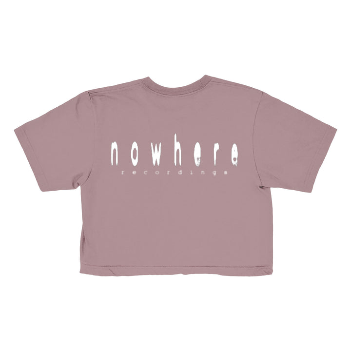 A mauve cropped t-shirt from Saphir Levi, featuring nowhere recordings in a distorted, stretched white font on the back.
