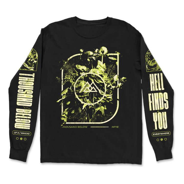 Black Gildan long-sleeve by Thousand Below with a classic fit, 100% cotton. Features green-yellow leafy plants and abstract symbols on the chest, sleeve text A Thousand Below and Hell Finds You, plus circular accents on the cuffs.