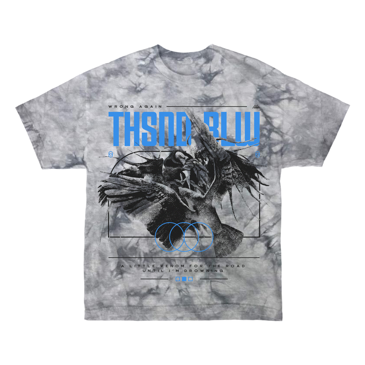 Thousand Below gray tie-dye T-shirt, made from 100% cotton, showcases an abstract winged figure with dark tones, blue THSND BLW text, and circular symbols. Finished with a tear-away label for comfort.