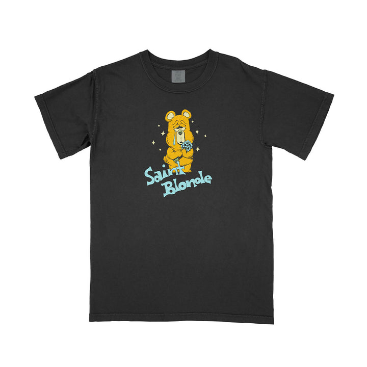 Saint Blonde black T-shirt with a cartoon dog in a yellow bear costume holding a flower, and "Saint Blonde" in blue text below the design.