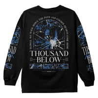 A black, long-sleeve Comfort Colors shirt from Thousand Below with blue and white broken glass graphics, the band name on the back, and the quote "Slowly, we walk down the path and colder hearts come home." Perfect for printed garment fans.