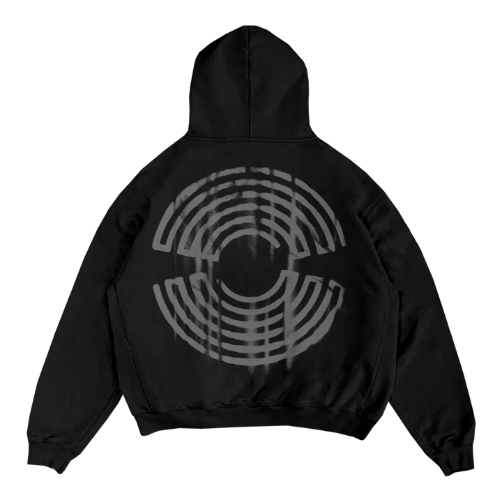 A Spiritbox black zip-up sweatshirt features a large gray circular abstract geometric design of concentric arcs and lines on the back, creating a distorted effect, set against a plain white background.