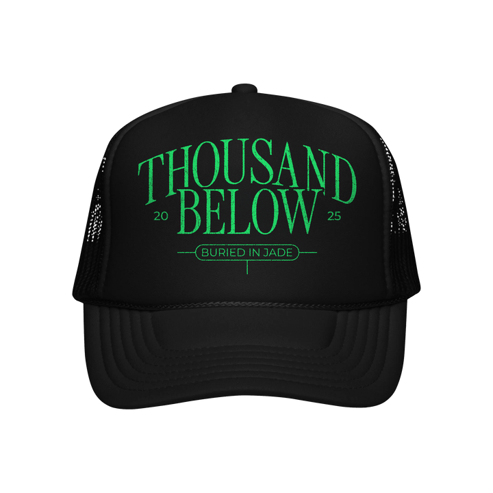 A premium black trucker hat from Thousand Below featuring green “THOUSAND BELOW 2025” and “BURIED IN JADE” text on the front—ideal for fans seeking an exclusive look during the presale.