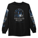 A black long-sleeve Thousand Below shirt features the band name in bold white text, a blue and white shattered glass graphic above it, and matching blue printed designs on both sleeves.