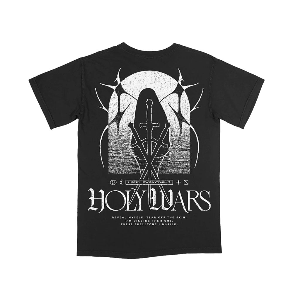 The Holy Wars black T-shirt features a white graphic of overlapping swords, an arched window with thorny branches, and haunting text: “I Feel Everything. Reveal myself. Tear off the skin. Endure what’s out. These skeletons buried.”.