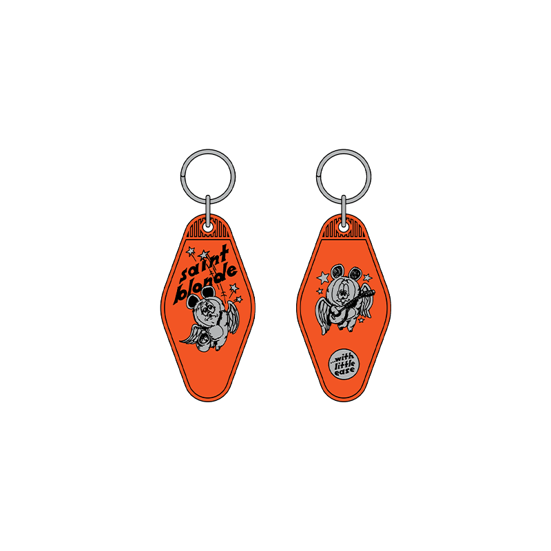 Two orange Saint Blonde motel-style keychains with metal rings feature cartoon bears and stars. One side reads "saint blonde," the other "United States of Texas." Available for presale; shipping starts 7/3/26!.