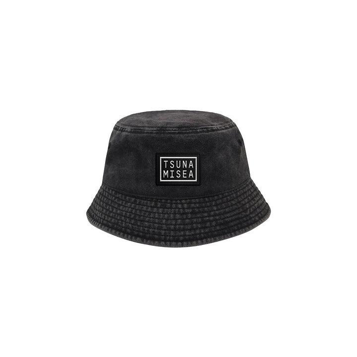 A Spiritbox Pigment Black Bucket Hat with a wide brim and a front rectangular patch featuring TSUNA MISEA in bold white letters, displayed on a plain white background.
