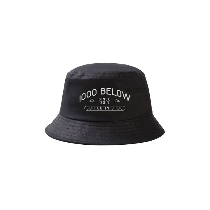 A black Thousand Below bucket hat with white "1000 BELOW SINCE 2011" text above a rectangle labeled "BURIED IN JADE.