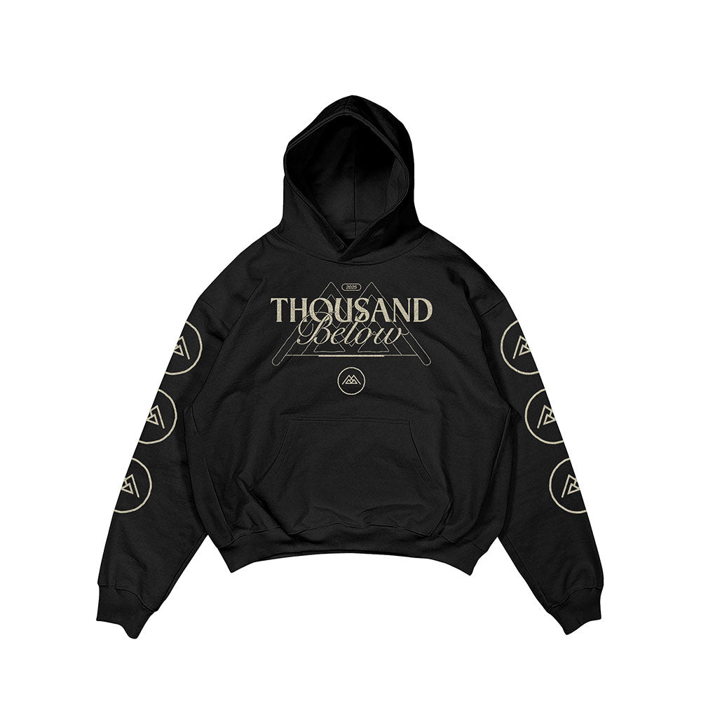 A black Thousand Below hoodie featuring beige front text, geometric designs above and below, and circular logo patterns on both sleeves.