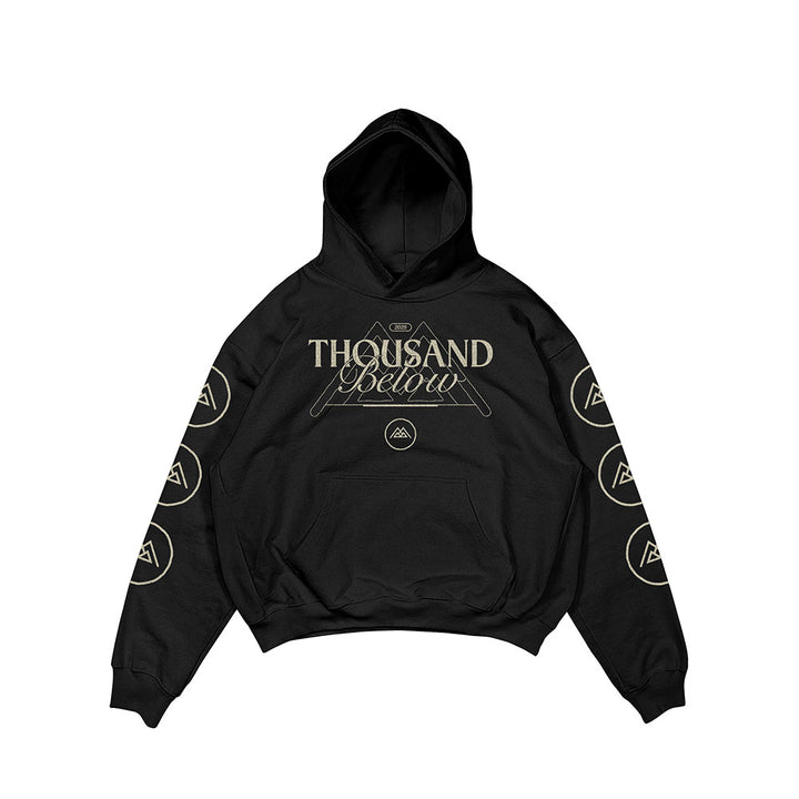 A black Thousand Below hoodie featuring beige front text, geometric designs above and below, and circular logo patterns on both sleeves.