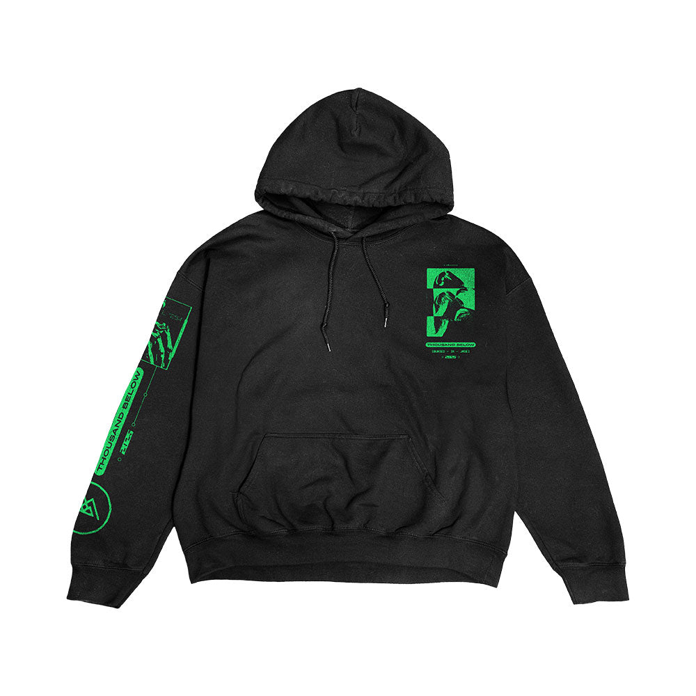 Thousand Below "Buried In Jade" black pullover hoodie with bright green graphics—abstract shapes, text, and a stylized face—on the left chest and right sleeve. Features a front pocket and drawstrings.