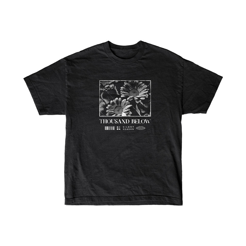 Black T-shirt by Thousand Below with a square grayscale flower graphic, "Thousand Below" and "Silent Season" text, and subtle barcode-inspired details below the design.