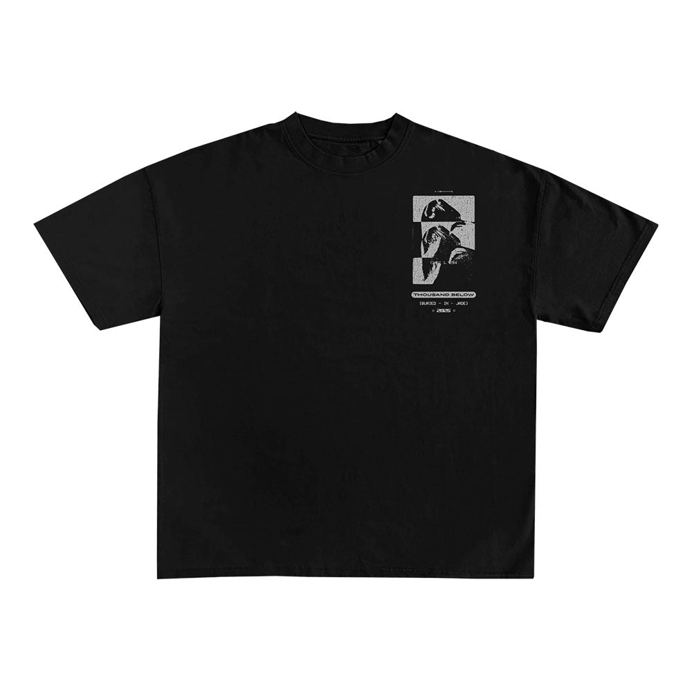 Black T-shirt by Thousand Below with a small, monochrome left chest graphic showing two abstract portraits and minimal "Buried In Jade" text below.