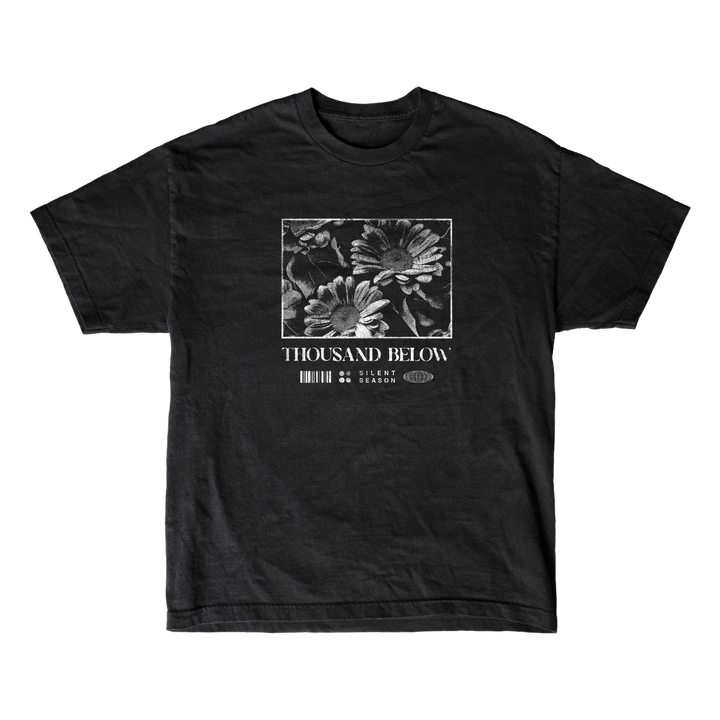 Black T-shirt by Thousand Below featuring a black-and-white floral chest design and logo text, made from soft ring-spun cotton with a modern classic fit—available as Gildan Softstyle T-Shirts.