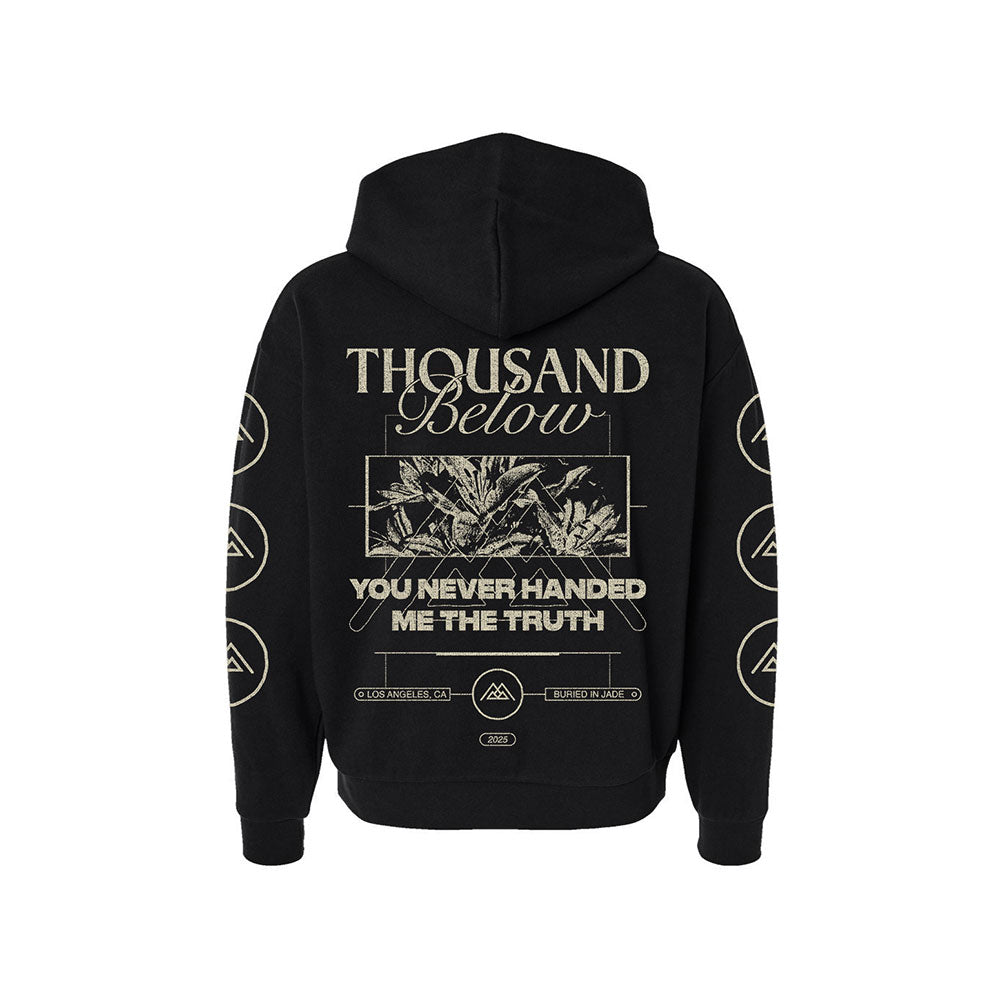 Black hoodie by Thousand Below featuring the band's name on the back above a leaf image, with "YOU NEVER HANDED ME THE TRUTH" below. Circular symbols appear along the sleeves.