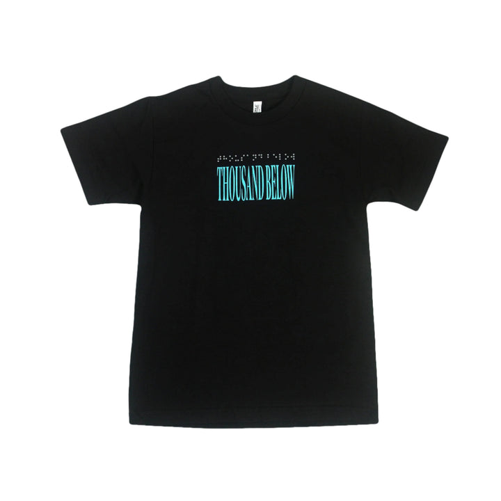 Thousand Below black T-shirt featuring large light blue THOUSAND BELOW text on the front with smaller white text above. Relaxed fit, made from 100% cotton Alstyle Heavyweight tee. Shown on a plain white background.